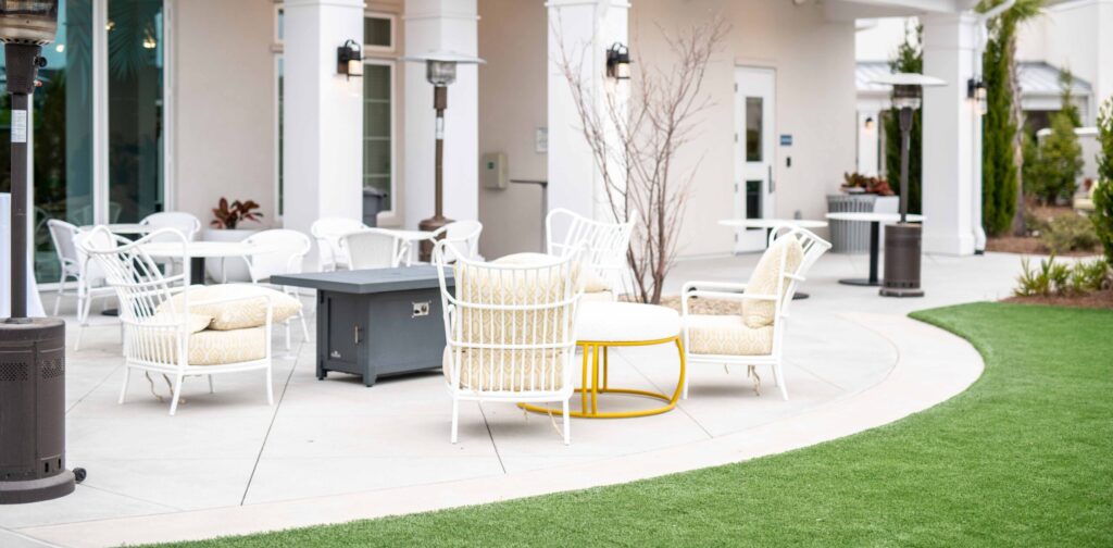 _DSC1712 - Portside at Grande Dunes Portside at Grande Dunes cafe lawn with white cushioned chairs and a white cushioned coffee table.